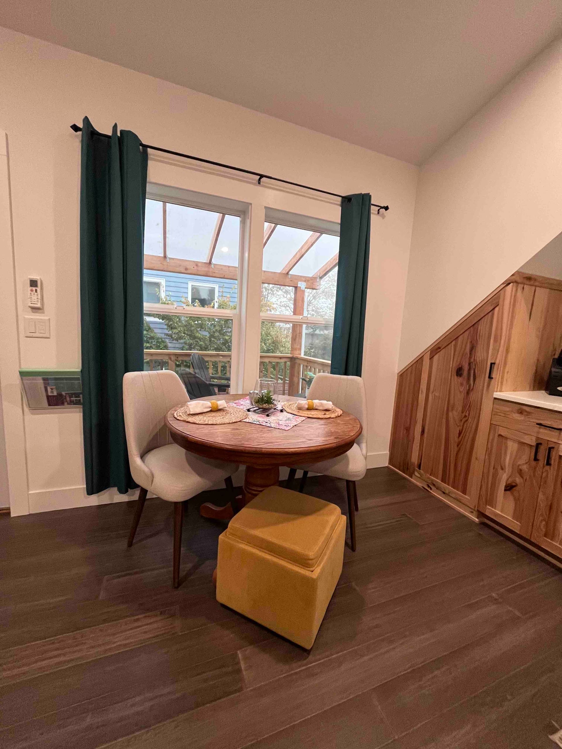 Cozy dining nook with a round table beside cedar-paneled walls