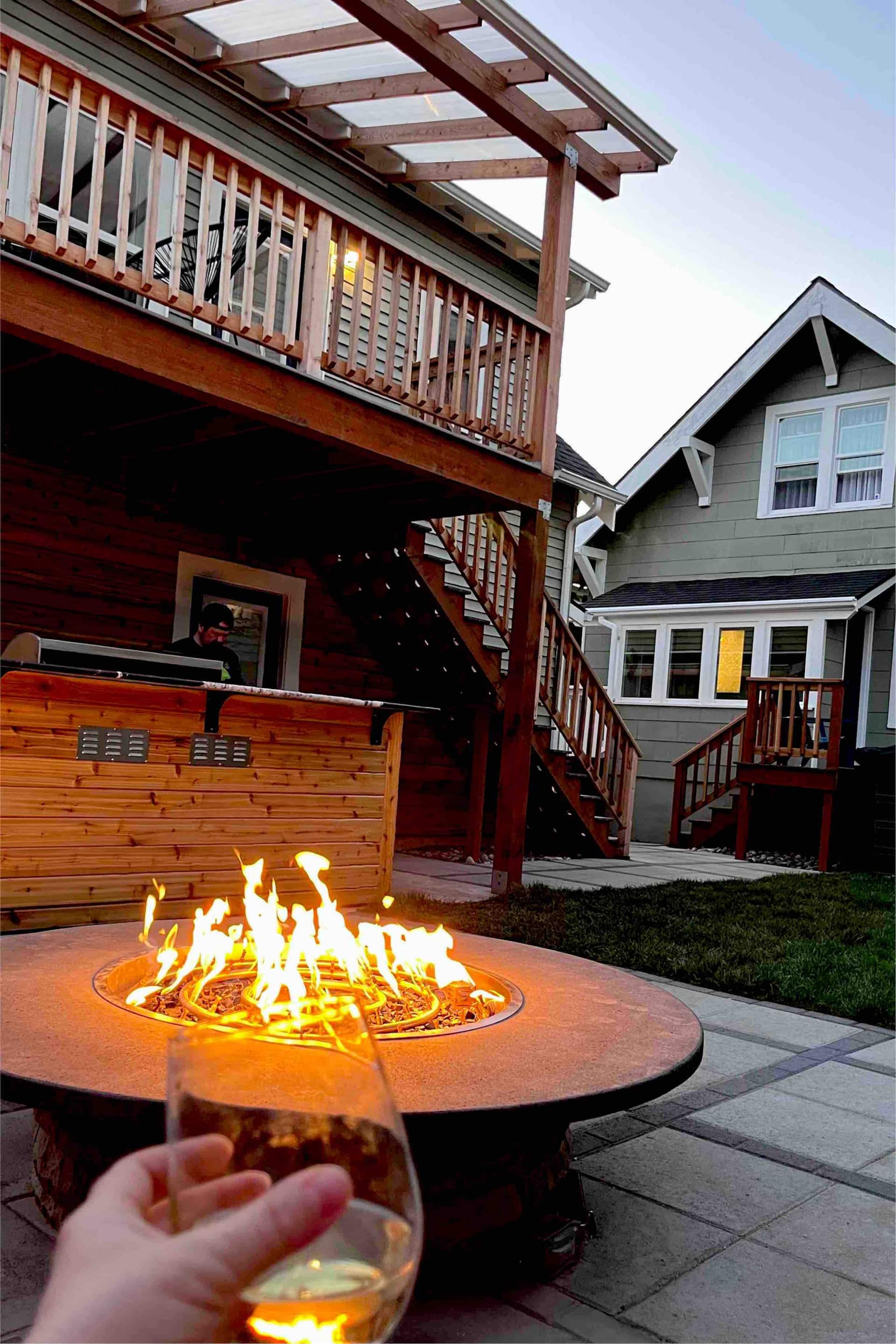 Gas fire pit lit on the patio in the evening