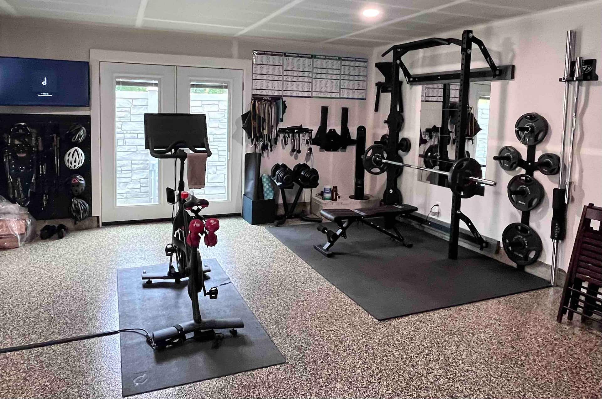 Private at-home gym with a stationary bike and free weights