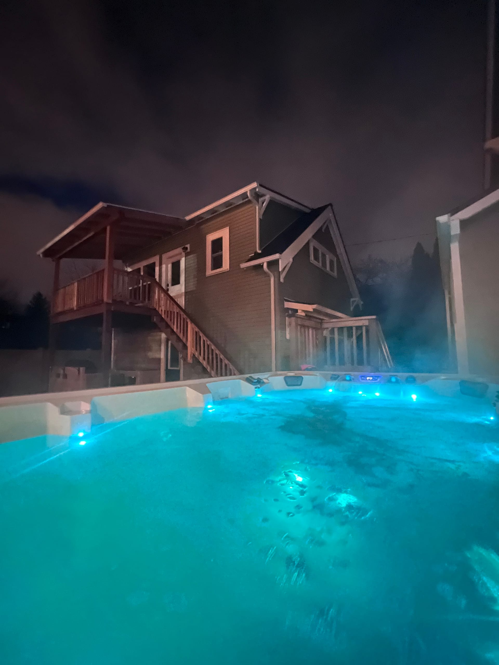 The swim spa glowing warm at dusk