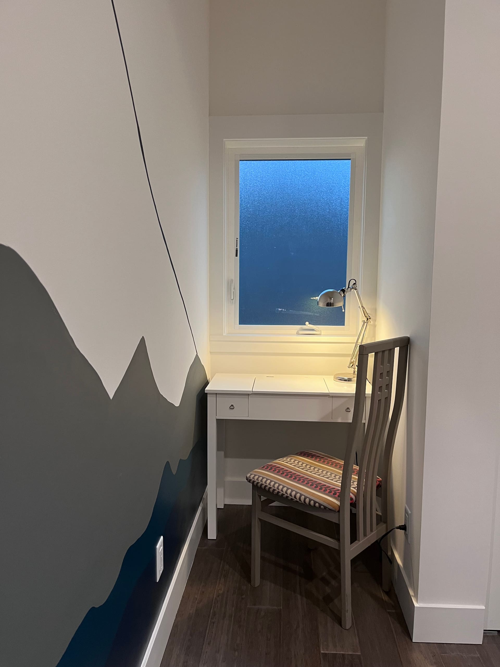 Dedicated workspace with a desk against a painted mountain mural
